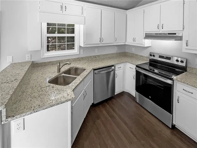a kitchen with a sink stove and cabinets