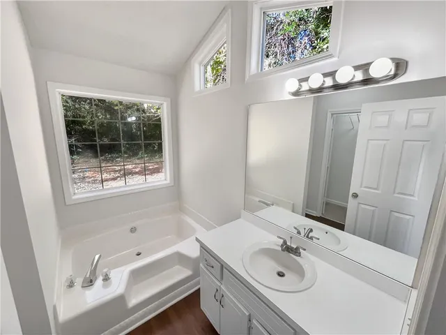 a kitchen that has a sink a stove and a window