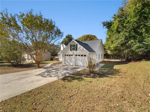 a view of an empty room with a fireplace and a window