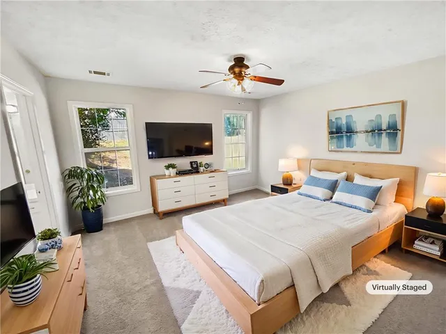 a view of a kitchen with wooden floor and a window
