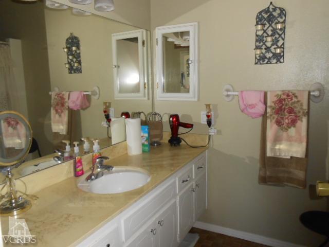 2450 Fitzgerald Road Simi Valley, CA 93065 - Photo 11 of 14 a bathroom with a sink vanity and mirror