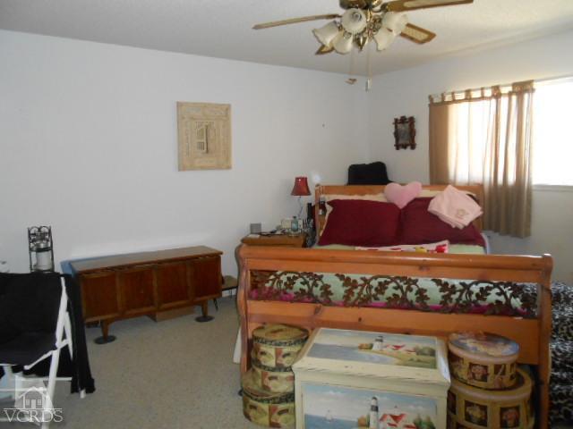2450 Fitzgerald Road Simi Valley, CA 93065 - Photo 12 of 14 a bedroom with a bed and a chandelier
