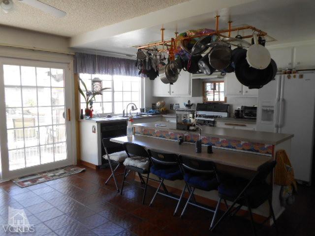 2450 Fitzgerald Road Simi Valley, CA 93065 - Photo 5 of 14 a kitchen with a table chairs and a wooden floor