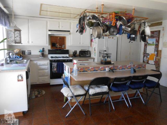 2450 Fitzgerald Road Simi Valley, CA 93065 - Photo 6 of 14 a view of a dining room with furniture and a kitchen