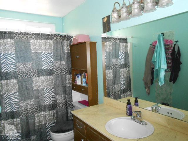 2450 Fitzgerald Road Simi Valley, CA 93065 - Photo 7 of 14 a bathroom with a granite countertop sink and a mirror