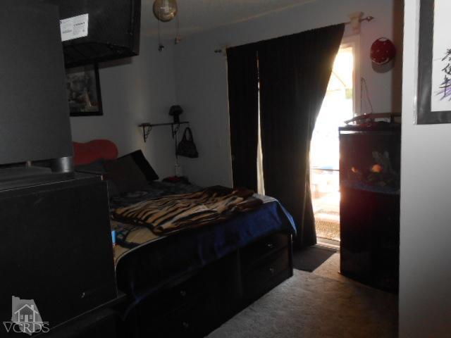 2450 Fitzgerald Road Simi Valley, CA 93065 - Photo 8 of 14 a bedroom with a bed and a potted plant next to a window