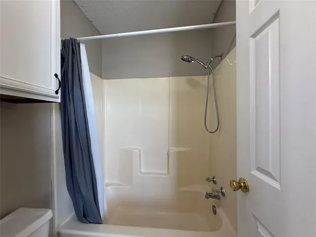 a bathroom with a shower and a toilet