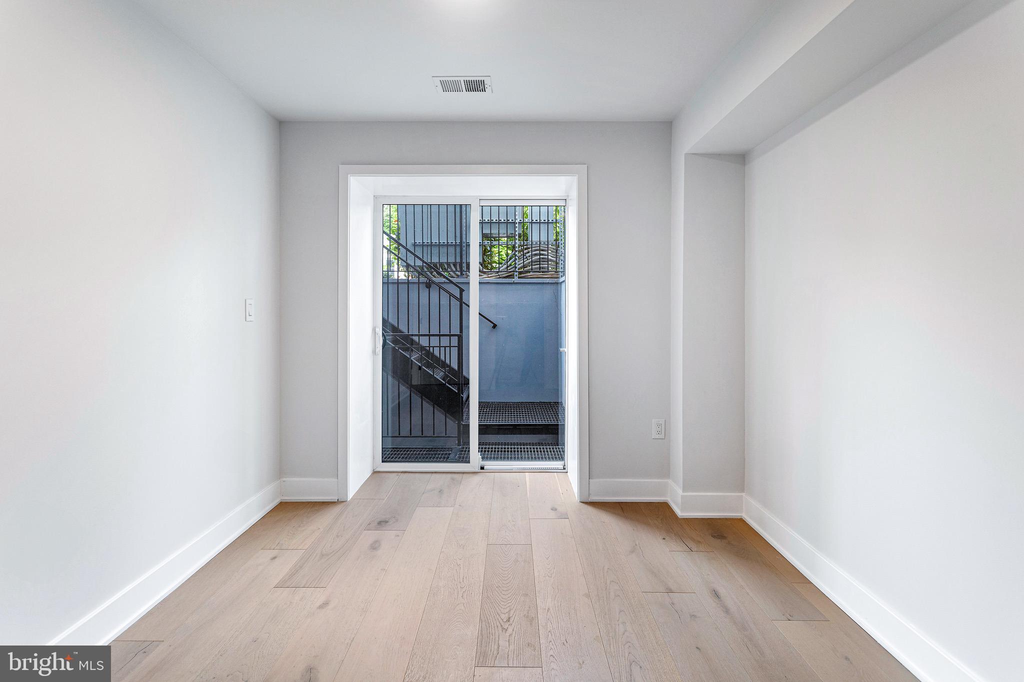 845 19th Street Northeast, Unit 4 Washington, DC 20002 - Photo 4 of 14 an empty room with wooden floor and entrance