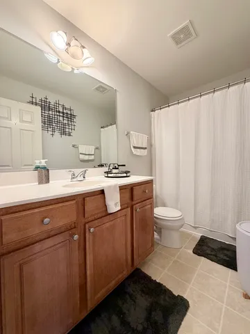 a bathroom with a sink a toilet and mirror