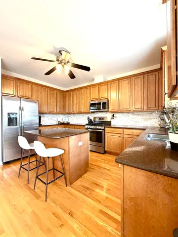 a kitchen with stainless steel appliances granite countertop a stove a sink dishwasher a microwave oven with granite countertops and cabinets