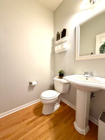 a bathroom with a sink toilet and mirror