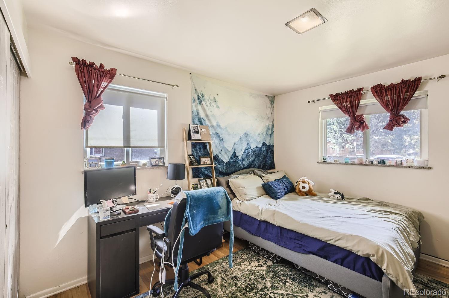 3205 Moorhead Avenue Boulder, CO 80305 - Photo 7 of 11 a bedroom with a bed and wooden floor