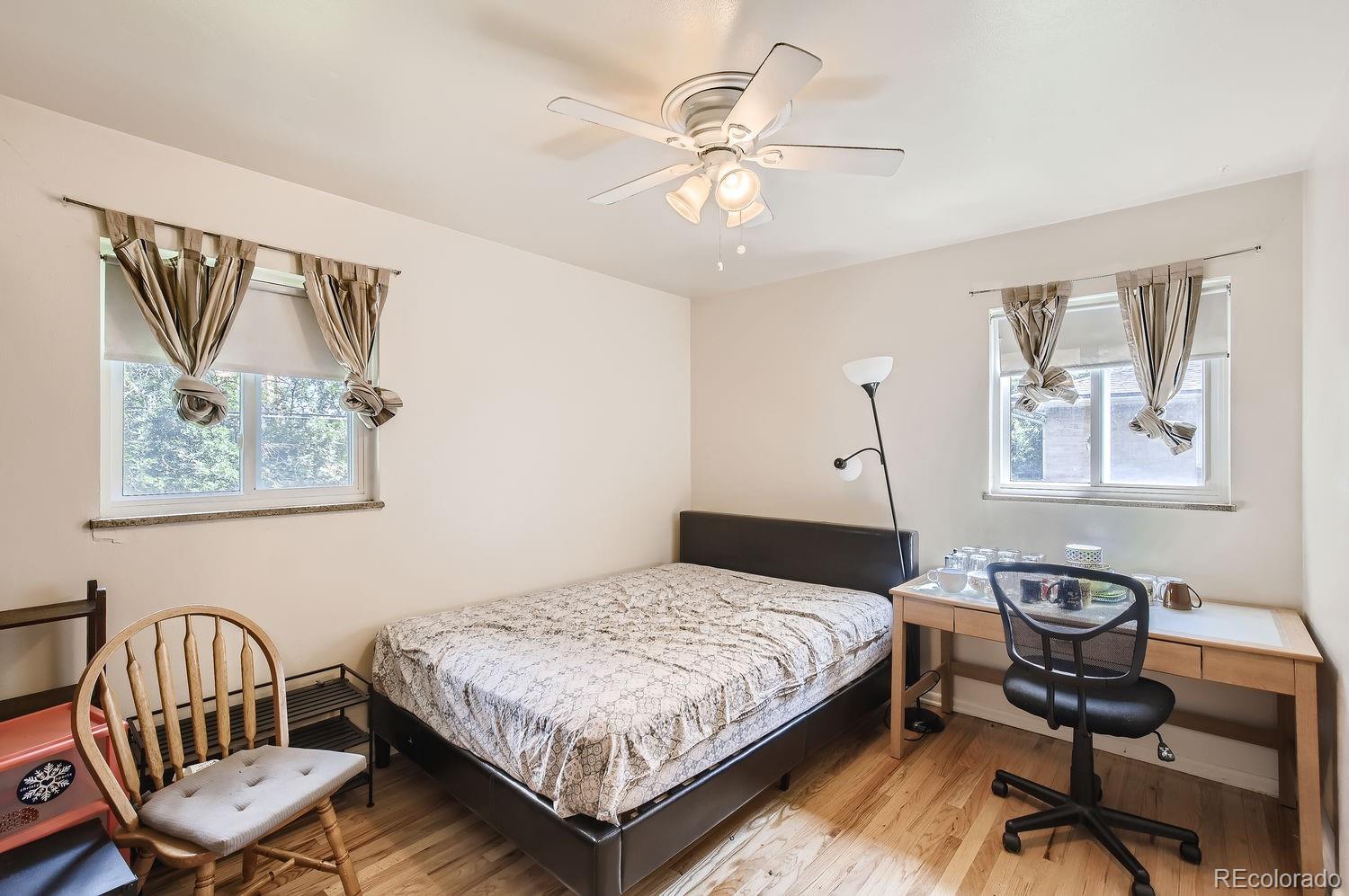 3205 Moorhead Avenue Boulder, CO 80305 - Photo 8 of 11 a bedroom with a bed and a chandelier