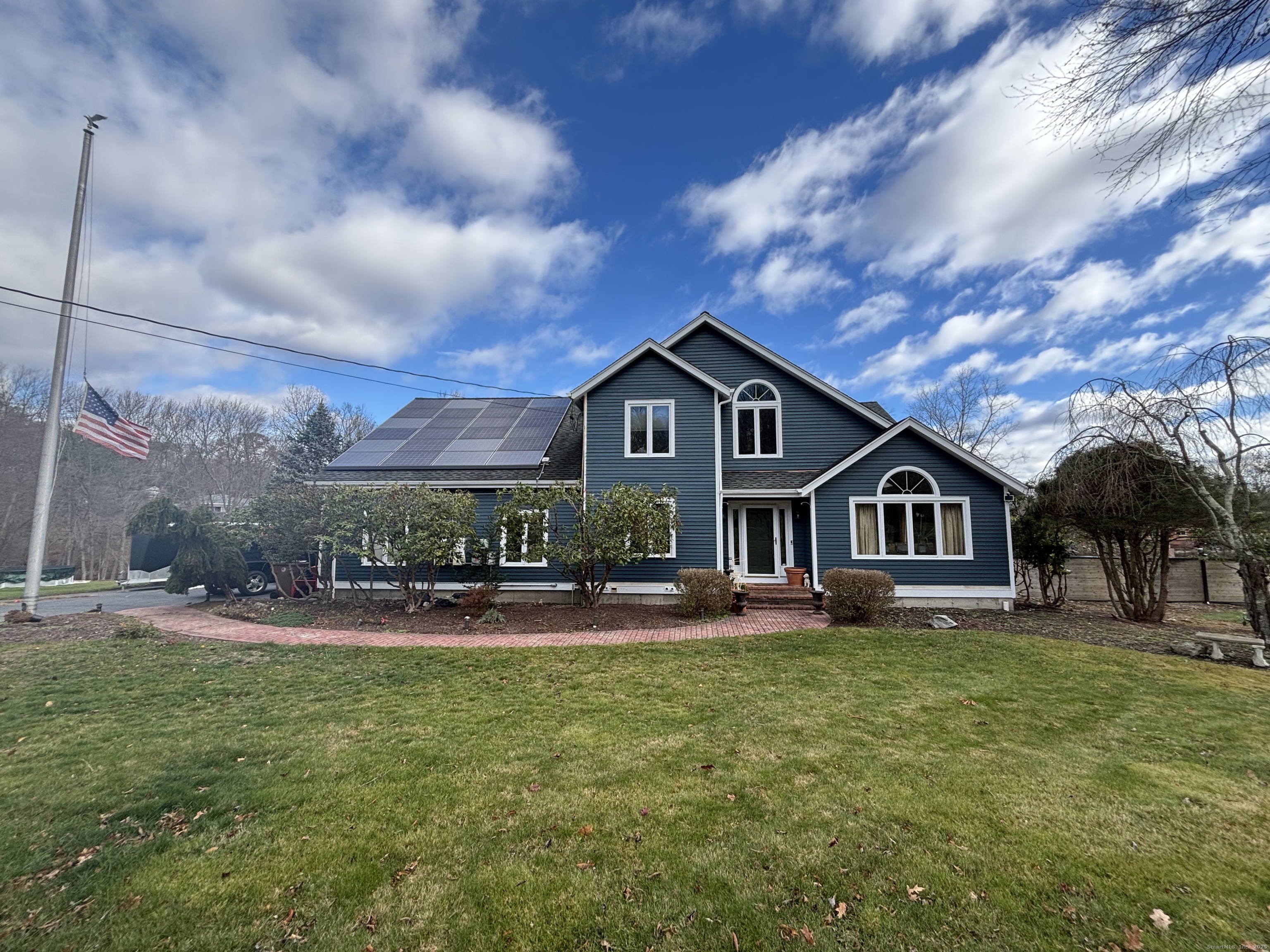 a front view of house with yard and green space