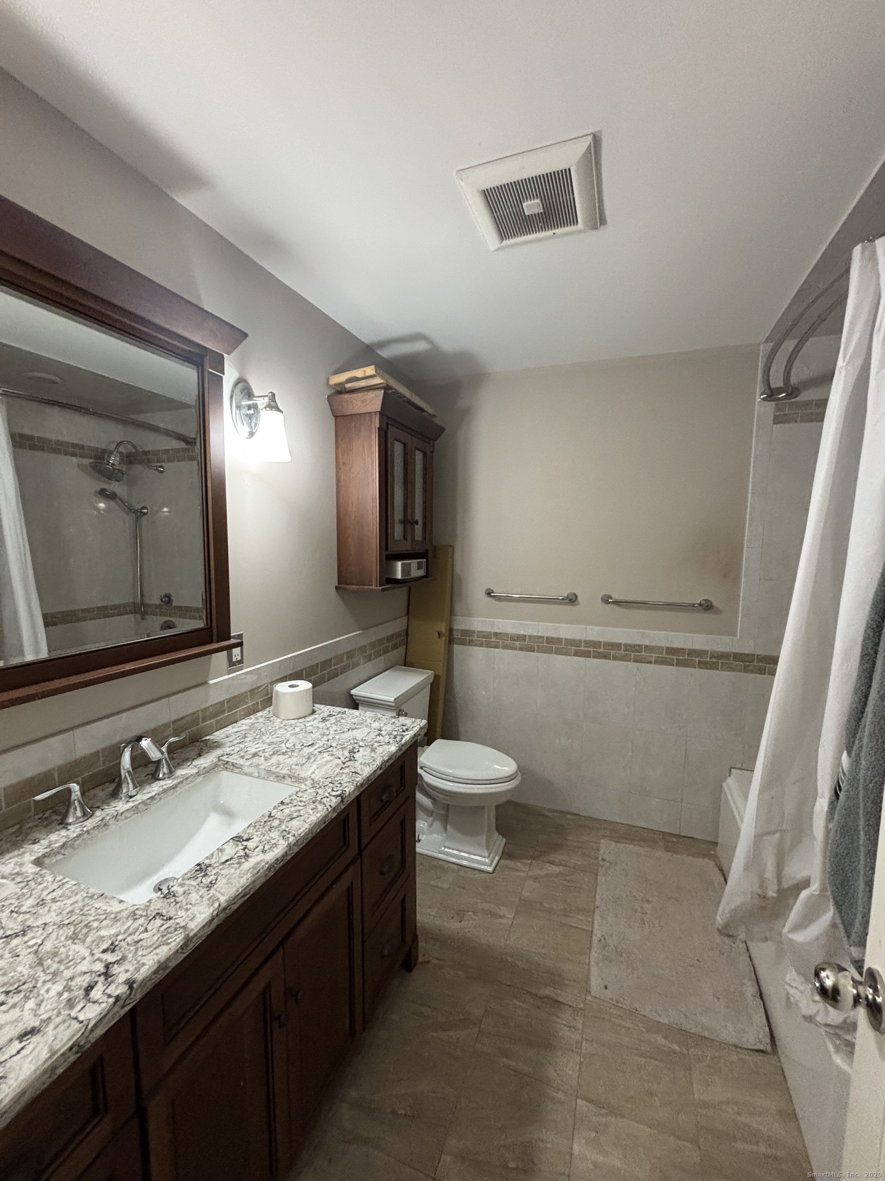 33 Walnut Tree Hill Road Shelton, CT 06484 - Photo 17 of 27 a bathroom with a granite countertop sink a large mirror and toilet