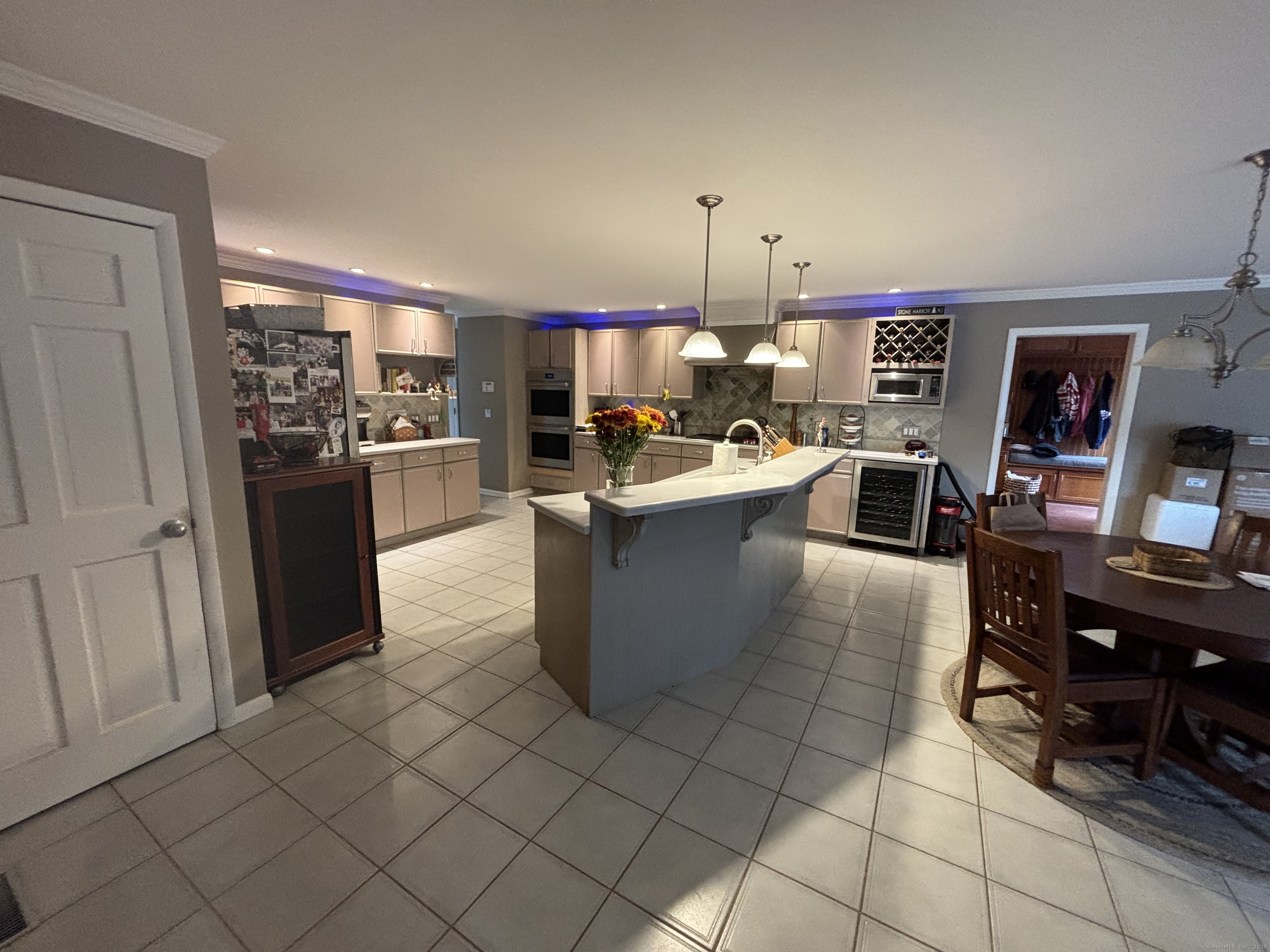 33 Walnut Tree Hill Road Shelton, CT 06484 - Photo 5 of 27 a kitchen with stainless steel appliances a refrigerator a sink a stove top oven a washer dryer and a dining table