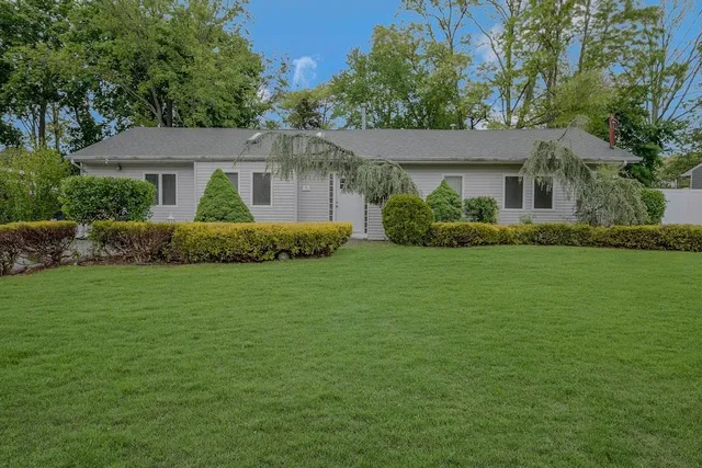 a front view of a house with a garden