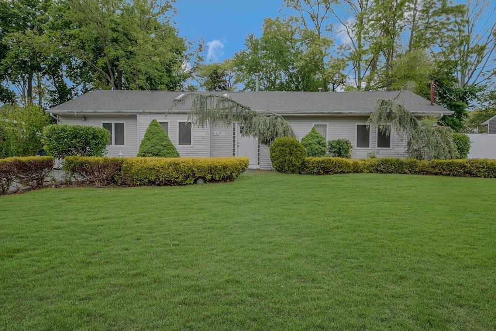 a front view of a house with a garden