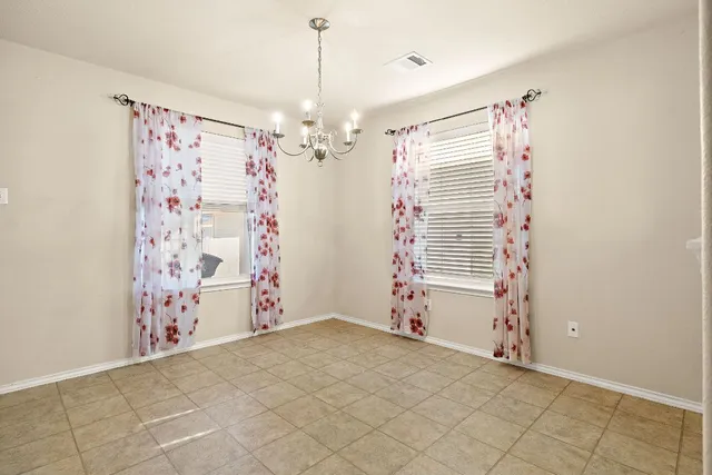 a view of a room with window and chandelier
