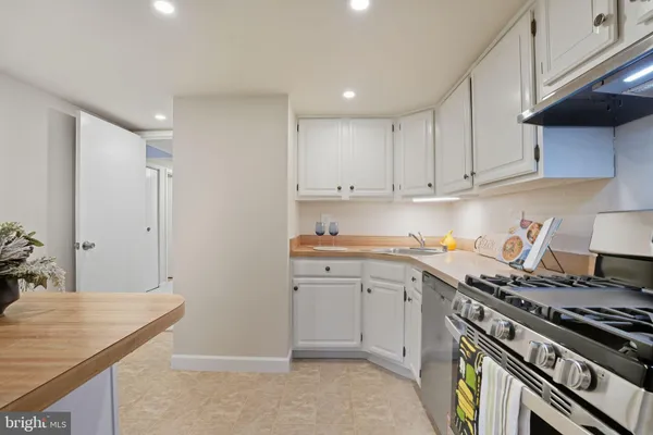 a kitchen with a stove and white cabinets