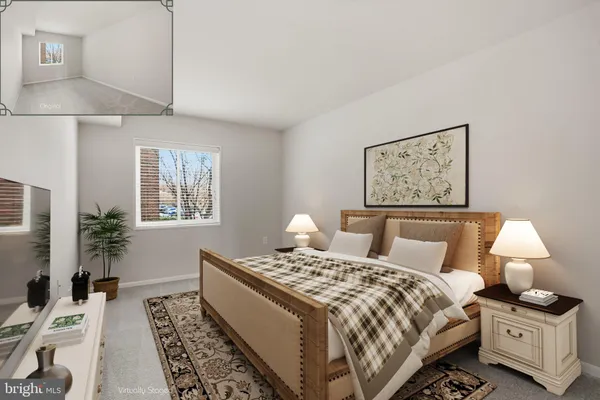 a bedroom with a bed and a lamp on table