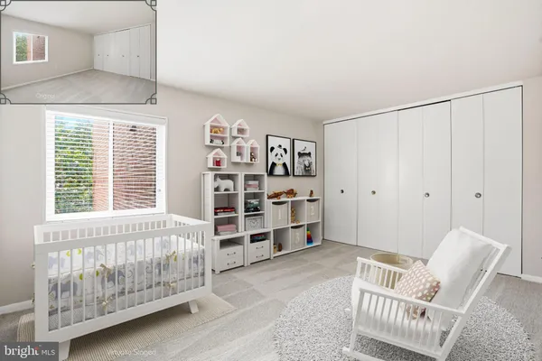 a living room with furniture and baby crib