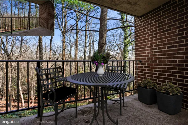 a view of a patio with a table and chairs