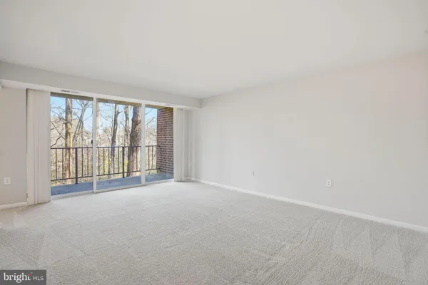 a view of an empty room with a balcony