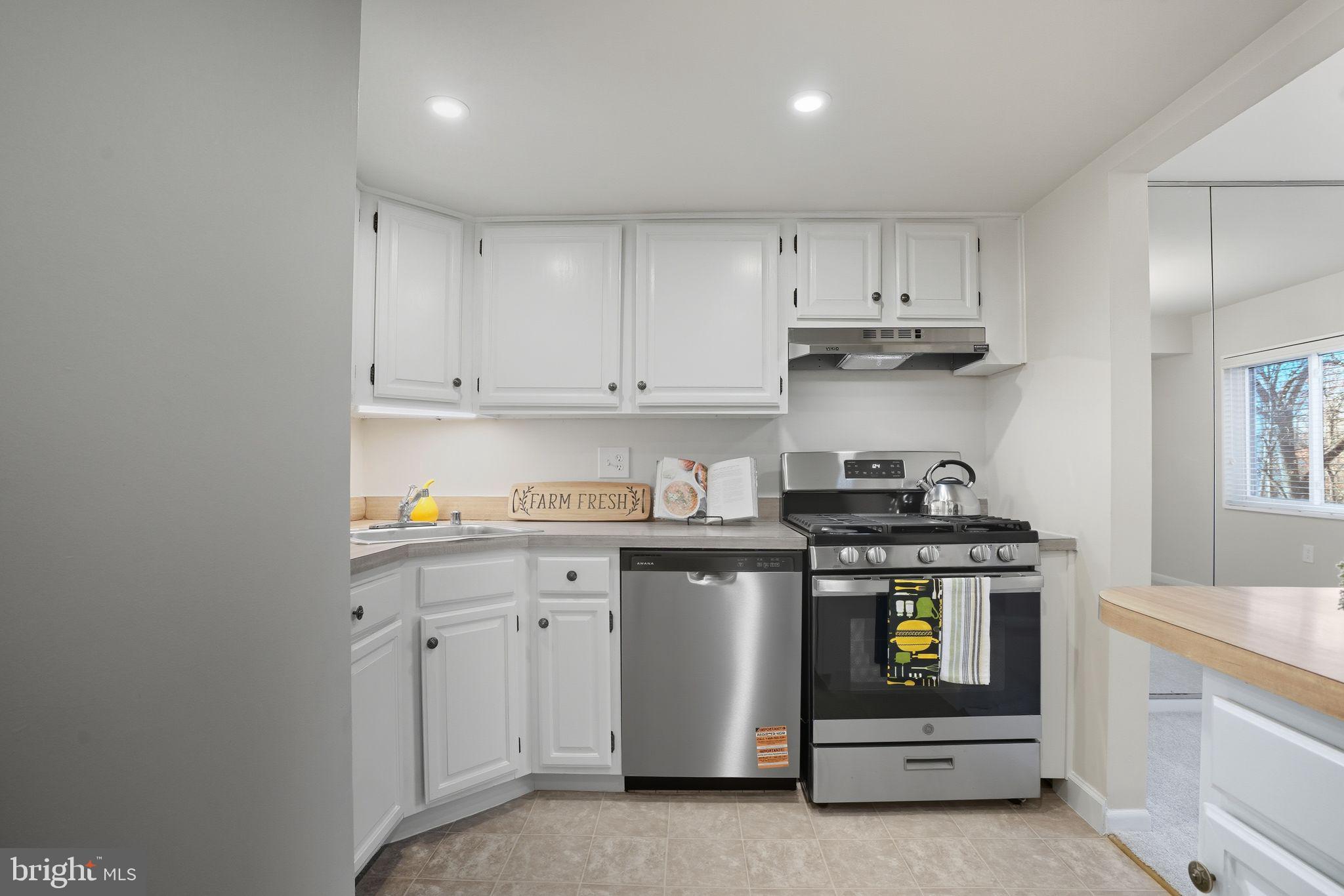 1552 Northgate Square, Unit 12B Reston, VA 20190 - Photo 3 of 23 a kitchen with stainless steel appliances granite countertop a stove and a white cabinets