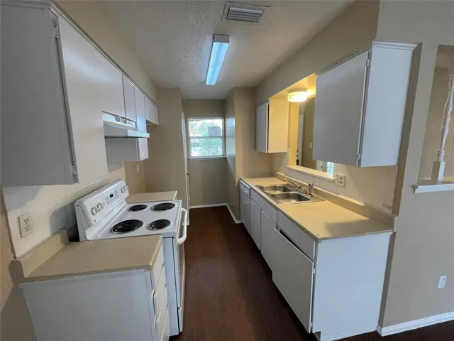 a kitchen that has a sink and a stove
