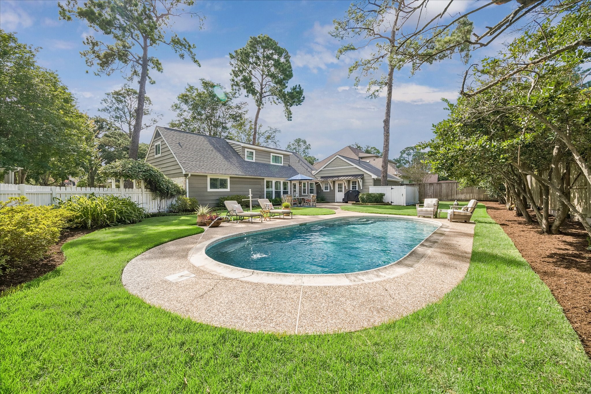 12615 Taylorcrest Road Houston, TX 77024 - Photo 28 of 29 The backyard is a tranquil setting and boasts plenty of green space. The pool was completely redone in 2024 with new pebble tech, tile, all new equipment, a heater and automation.