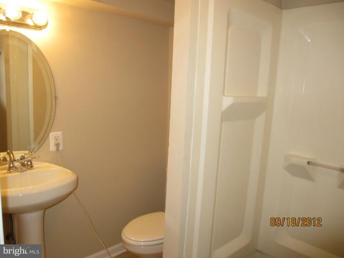 12418 Dewey Road Rockville, MD 20853 - Photo 15 of 20 a bathroom with a sink a toilet and shower