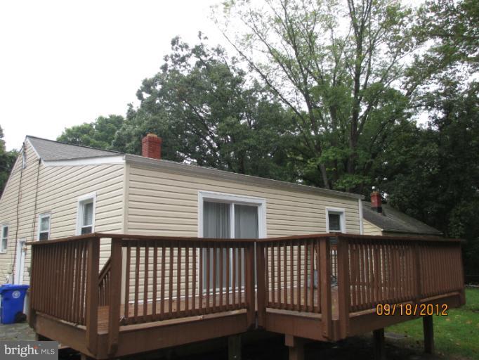 12418 Dewey Road Rockville, MD 20853 - Photo 3 of 20 a view of a white house with a large window and wooden fence