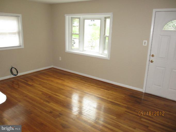 12418 Dewey Road Rockville, MD 20853 - Photo 5 of 20 a view of a room with wooden floor and windows