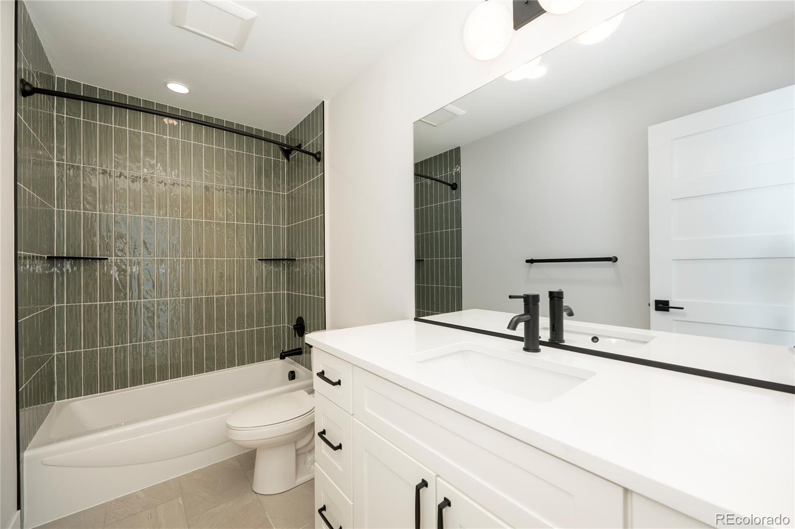 38 Wheeler Road Winter Park, CO 80482 - Photo 16 of 45 a bathroom with a sink toilet vanity and shower
