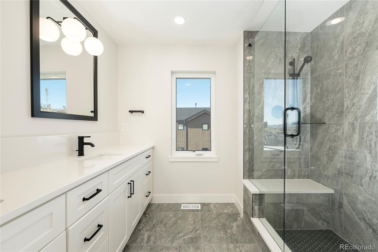 38 Wheeler Road Winter Park, CO 80482 - Photo 22 of 45 a bathroom with a shower sink and mirror