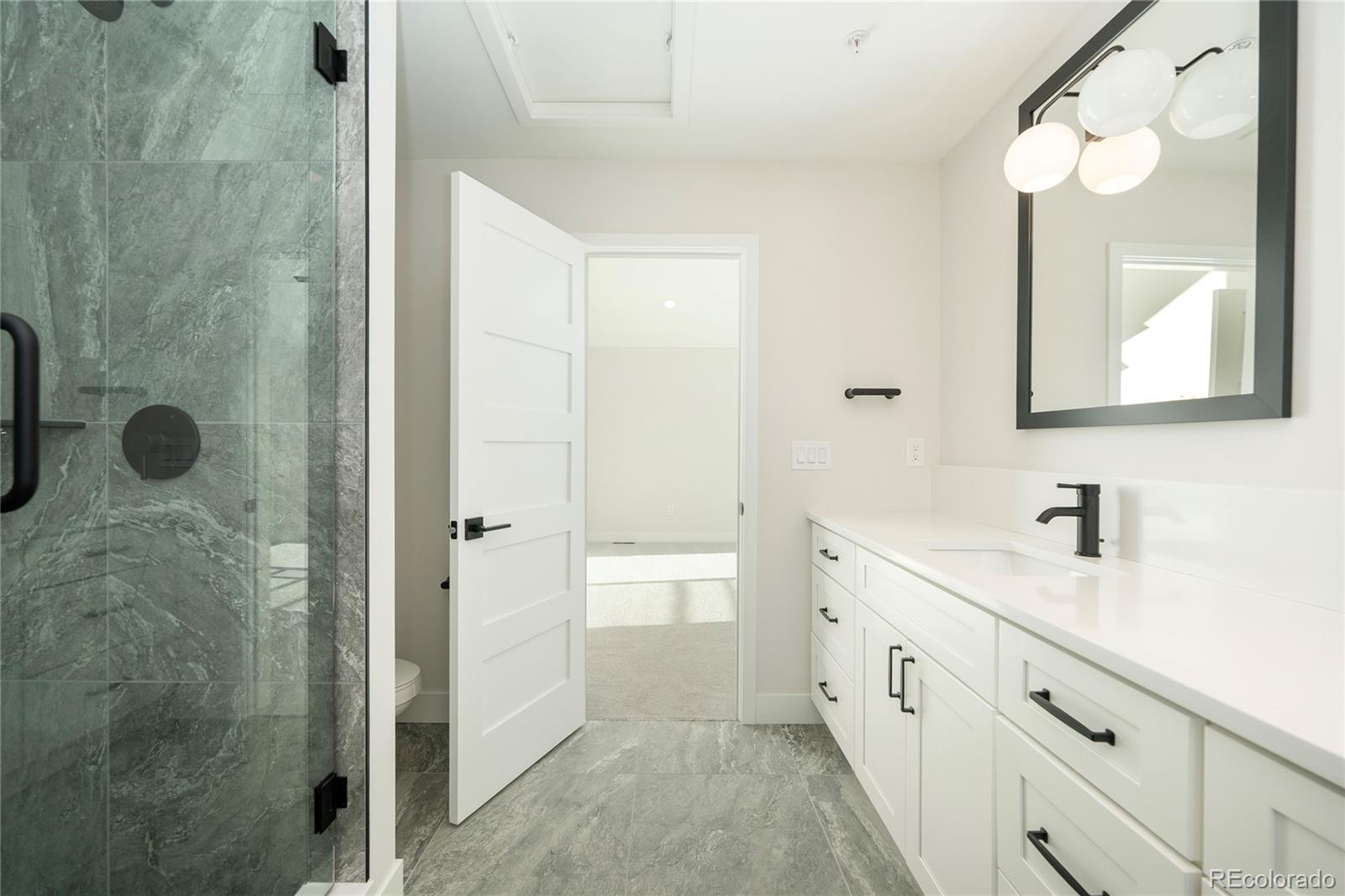 38 Wheeler Road Winter Park, CO 80482 - Photo 24 of 45 a spacious bathroom with a double vanity sink a mirror and shower