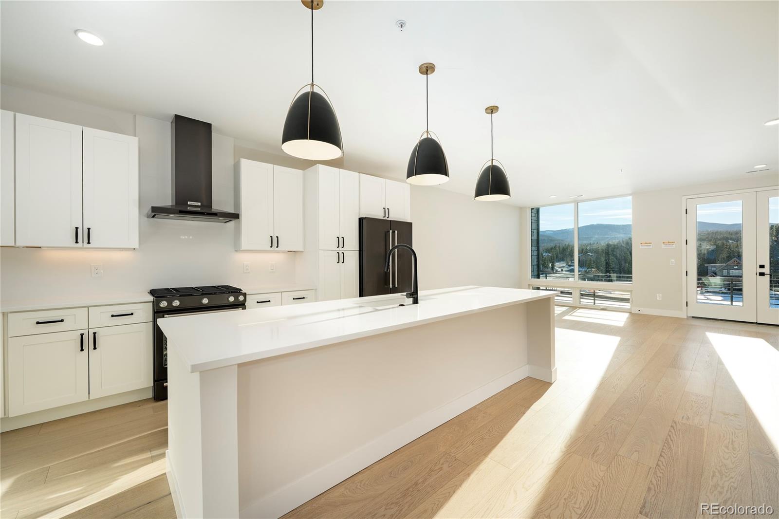 38 Wheeler Road Winter Park, CO 80482 - Photo 31 of 45 a kitchen with stainless steel appliances kitchen island a stove a sink a center island and windows