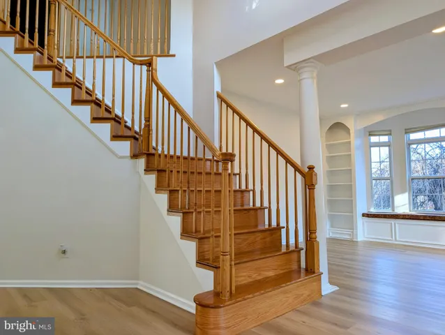 a view of entryway with wooden floor and stairs