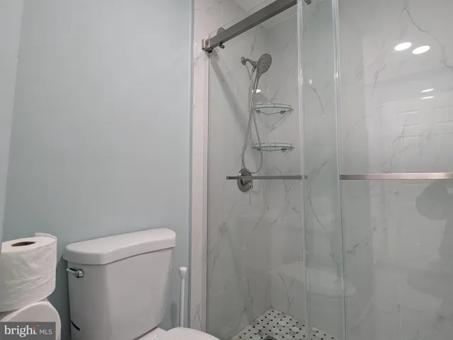 a bathroom with a toilet and a shower
