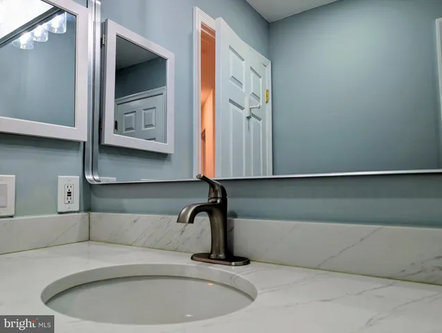 a bathroom with a sink and mirror