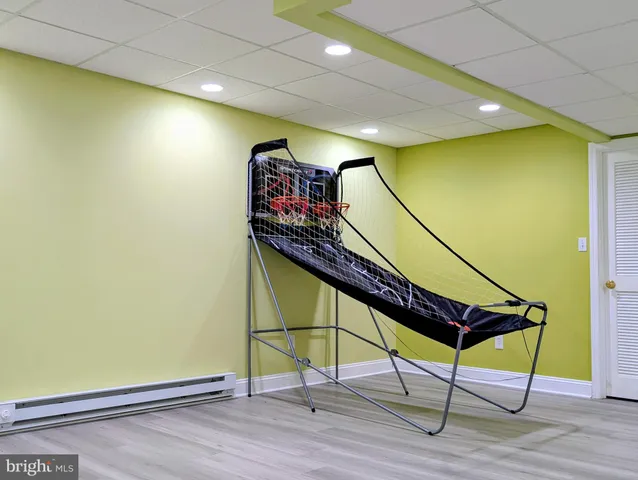 a room with wooden floor and windows