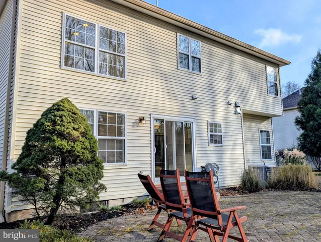 a backyard of a house with table and chairs