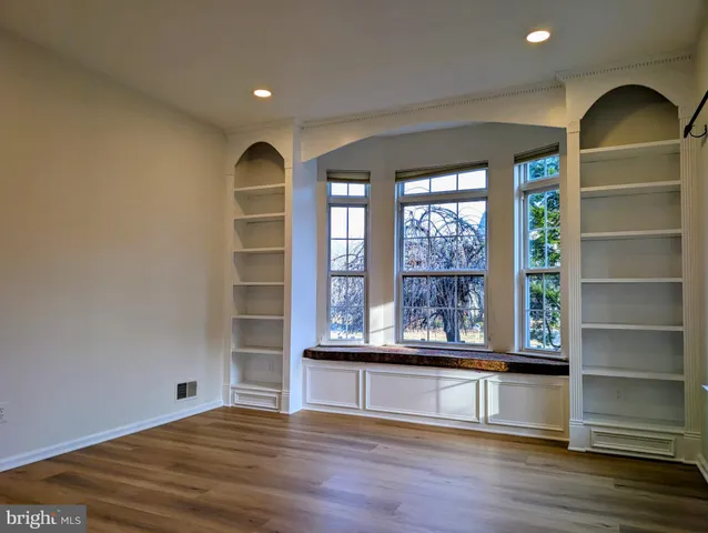 a view of a room with wooden floor and windows
