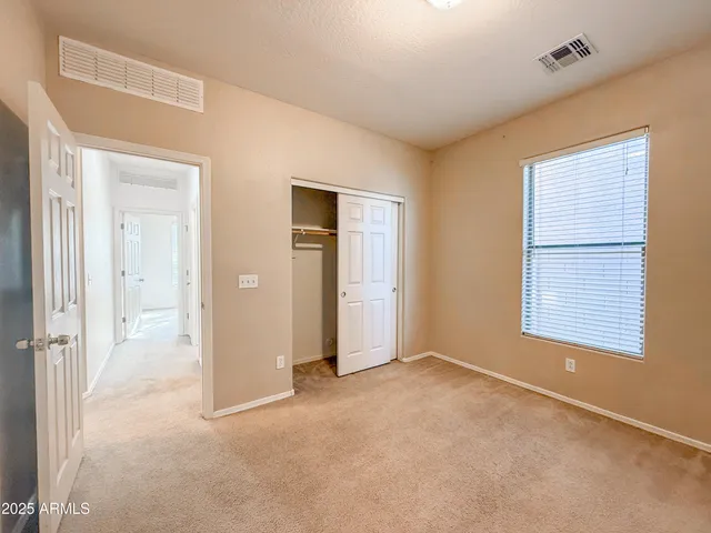 an empty room with closet area
