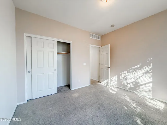a view of a livingroom with wooden floor and a window