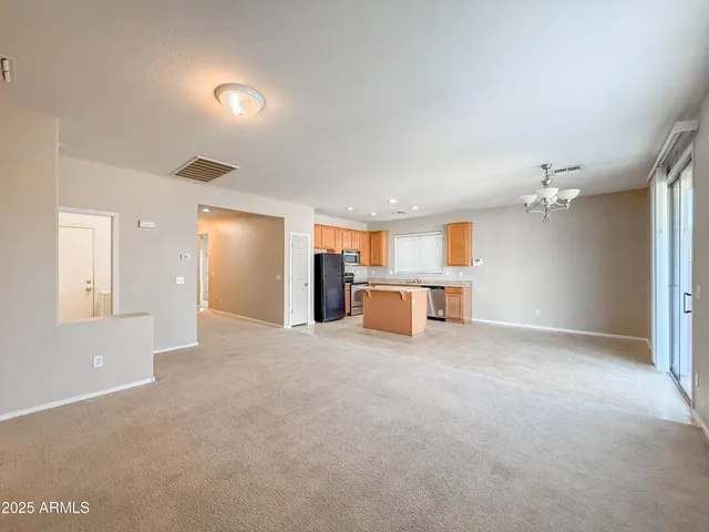 a view of kitchen with stainless steel appliances cabinets and refrigerator