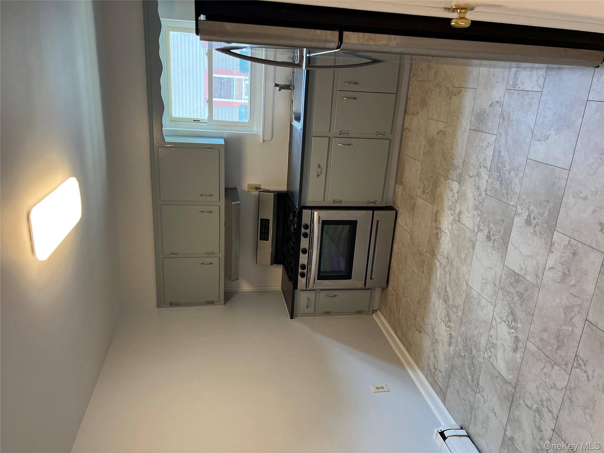 35 Prairie Avenue, Unit B Suffern, NY 10901 - Photo 4 of 11 a kitchen with a sink stove and cabinets