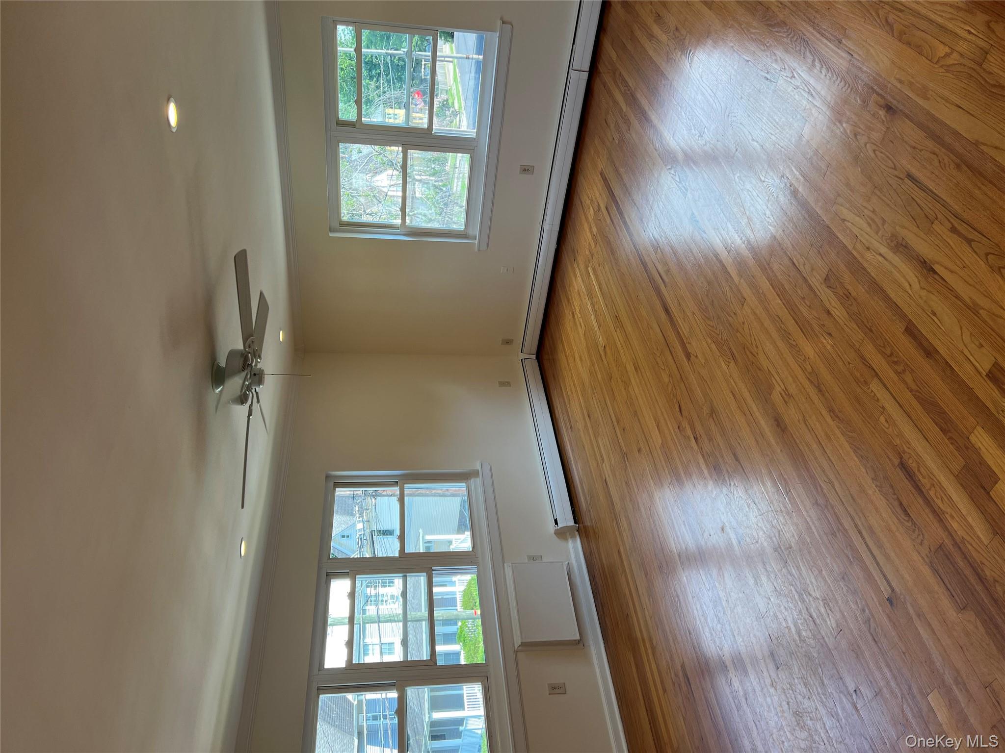 35 Prairie Avenue, Unit B Suffern, NY 10901 - Photo 5 of 11 an empty room with wooden floor and windows