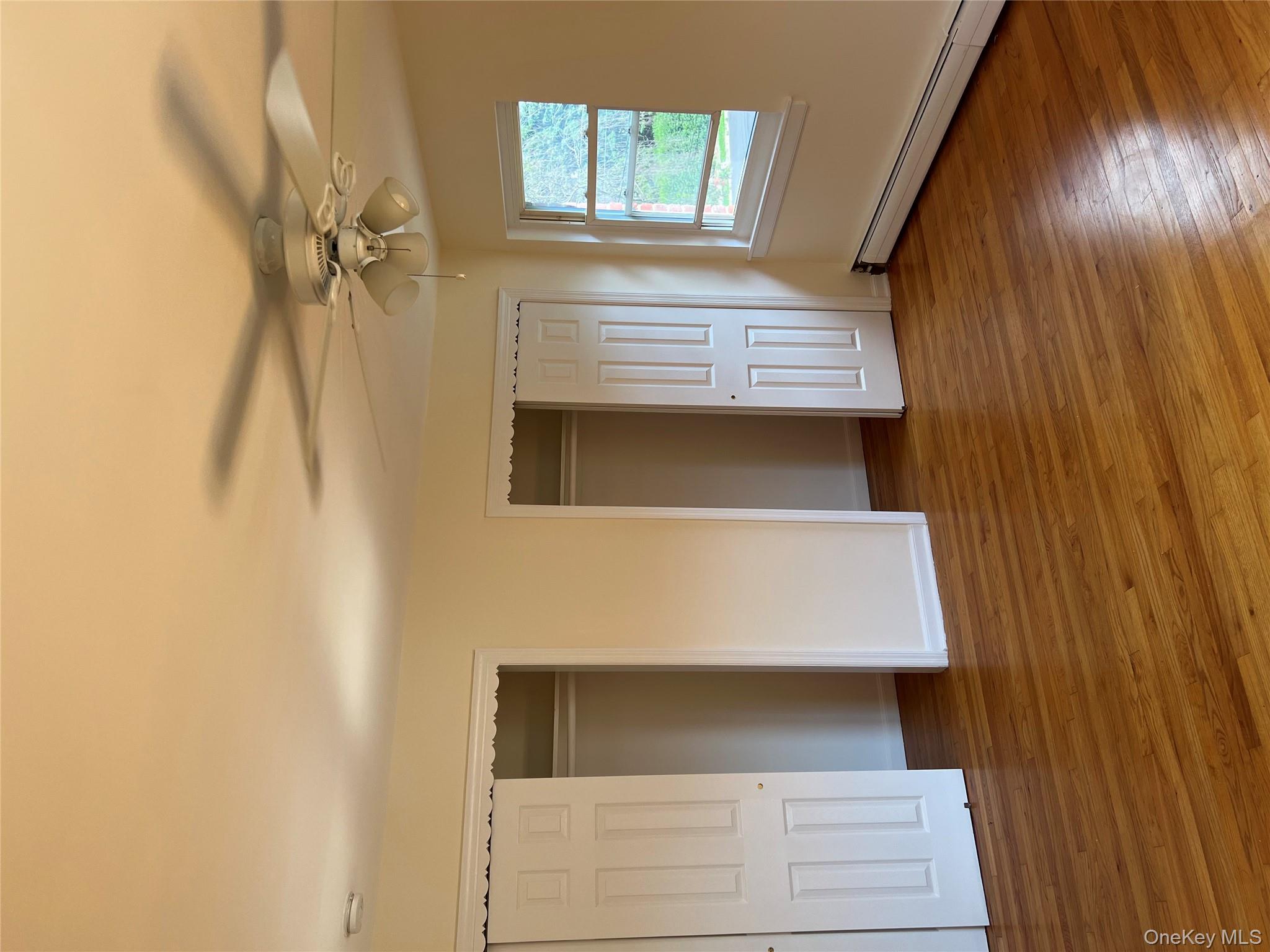 35 Prairie Avenue, Unit B Suffern, NY 10901 - Photo 6 of 11 a view of an empty room with wooden floor and a window